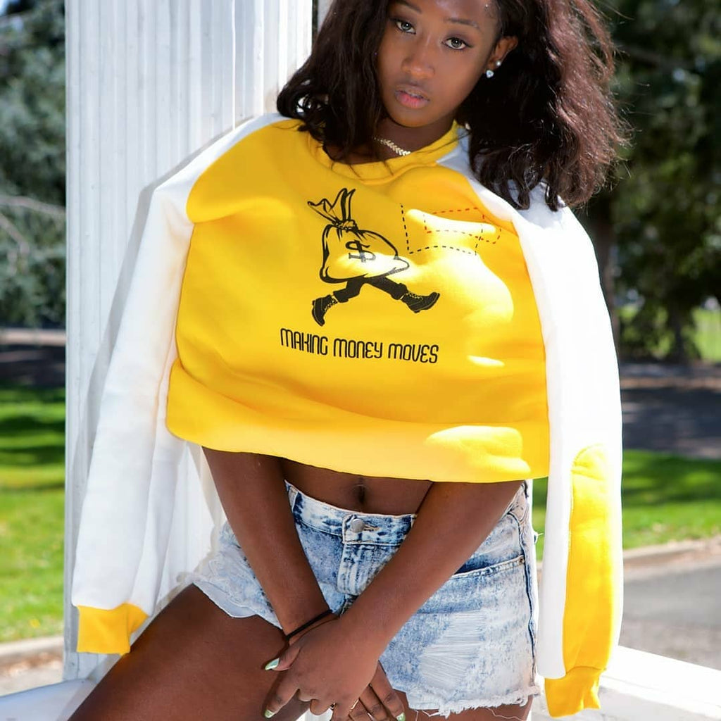 Yellow sweatshirt with white sleeve and blue arm patch accent