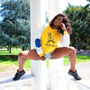 Yellow sweatshirt with white sleeve and blue arm patch accent